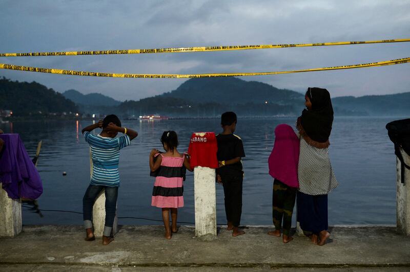Rohingya Muslim children stand at a port warehouse that is used as a temporary shelter in Sabang, Aceh province, Indonesia. Reuters