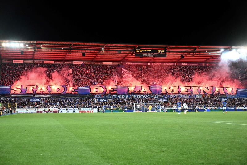 Strasbourg supporters display a giant banner and light flares at the end of the match between Strasbourg and PSG. AFP