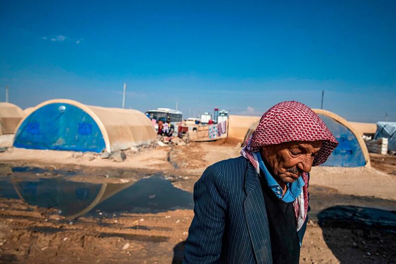 An elderly Syrian man, displaced from Ras al-Ain, a border town controlled by Turkey and its Syrian proxies, walks in front of tents in the camp of Washokani in the northeastern Syrian al-Hasakeh governorate, on November 12, 2020.   / AFP / Delil SOULEIMAN
