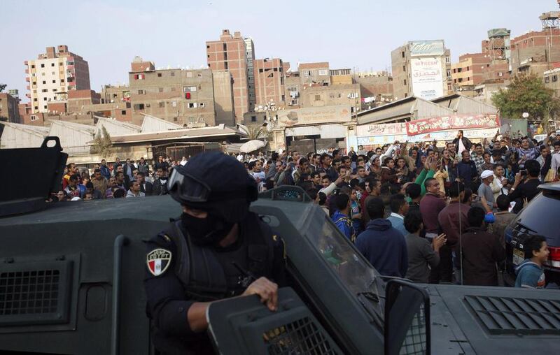 Police stand guard in the eastern Cairo suburb of Matariya, where two protesters were killed in clashes on  November 28, 2014. Asmaa Waguih / Reuters