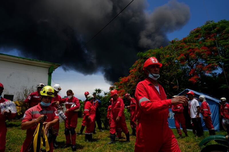 Members of the Cuban Red Cross prepare to go Matanzas, where firefighters are working to quell the blaze, which began during a thunderstorm. AP