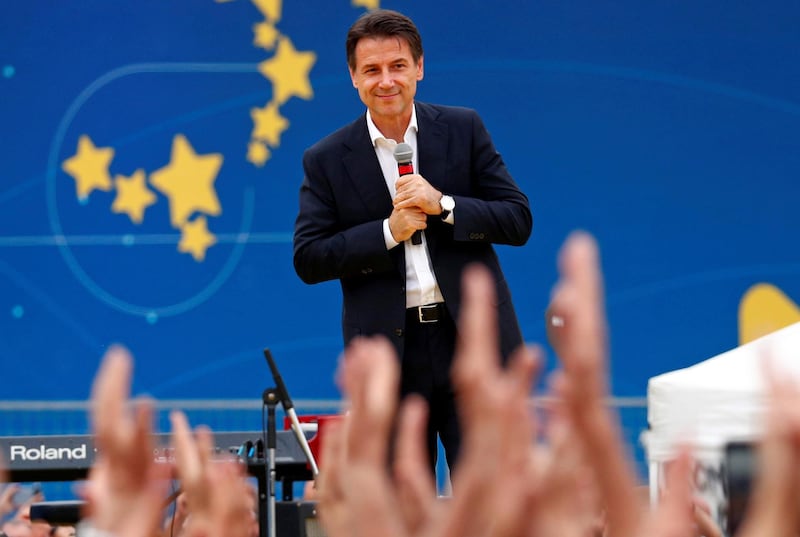 Italian Prime Minister Giuseppe Conte stands on stage at the 5-Star Movement party's open-air rally at Circo Massimo in Rome, Italy, October 21, 2018. REUTERS/Max Rossi