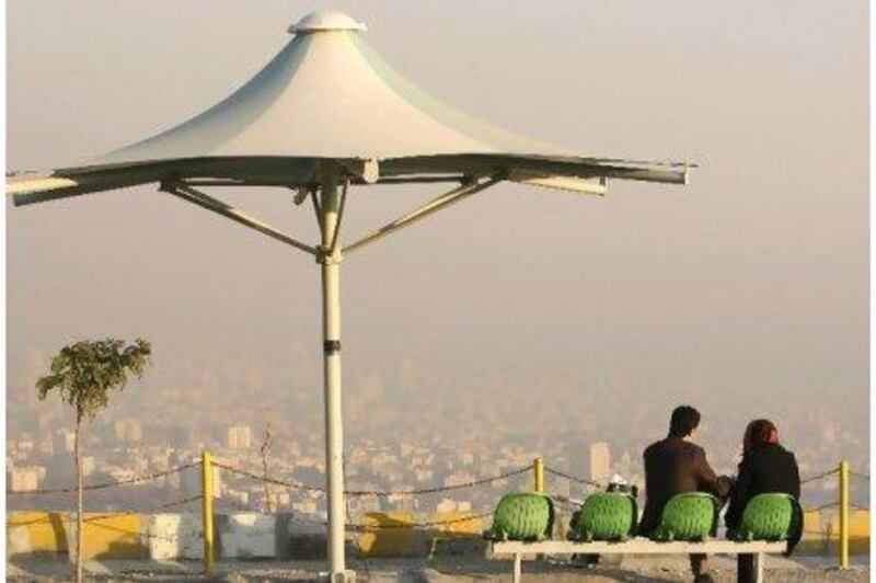 Iranians spend their time in the Tochal area, northern Tehran, as rooftops are seen in background, shrouded in polluted air. Heavy air pollution has forced Iranian authorities to close government offices and declare a two-day public holiday in the capital.