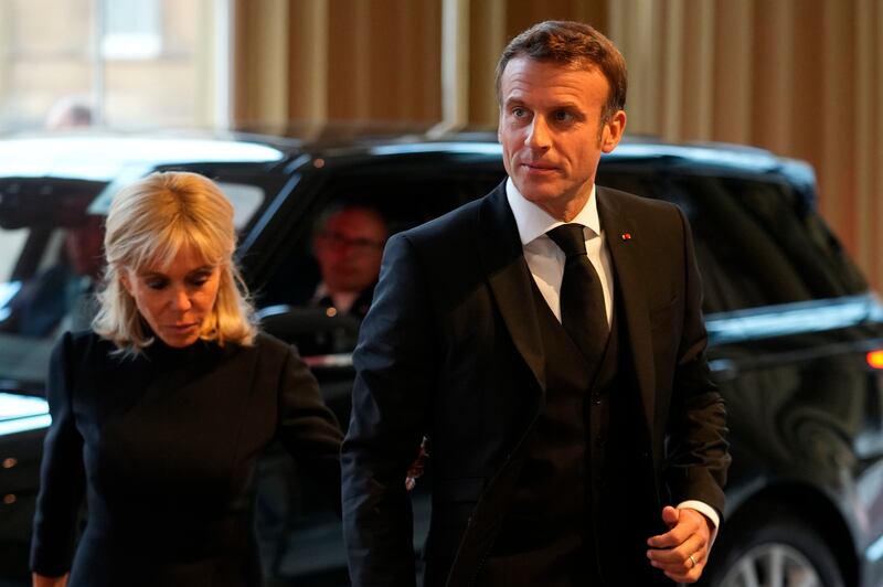 French President Emmanuel Macron and his wife Brigitte arrive for the reception hosted by King Charles. AP