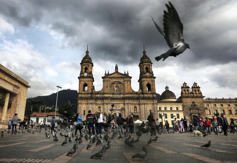 BOGOTA, COLOMBIA - OCTOBER 02:  A pigeon flies in Bolivar Square after Colombia's President Juan Manuel Santos cast his ballot there in the referendum on a peace accord to end the 52-year-old guerrilla war between the FARC and the state on October 2, 2016 in Bogota, Colombia. The guerrilla war is the longest-running armed conflict in the Americas and has left 220,000 dead. The plan called for a disarmament and re-integration of most of the estimated 7,000 FARC fighters. Colombians have voted to reject the peace deal in a very close vote. (Photo by Mario Tama/Getty Images)
