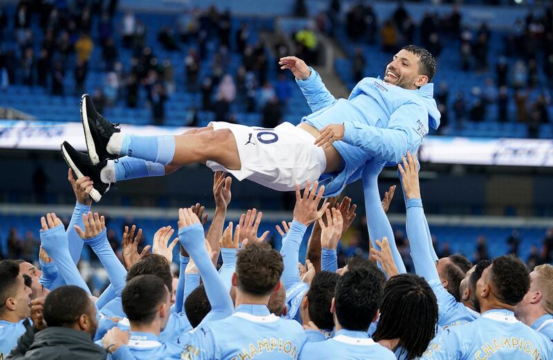 Manchester City players throw Sergio Aguero in the air to celebrate winning the Premier League title and his imminent exit from the club in May, 2021. AP