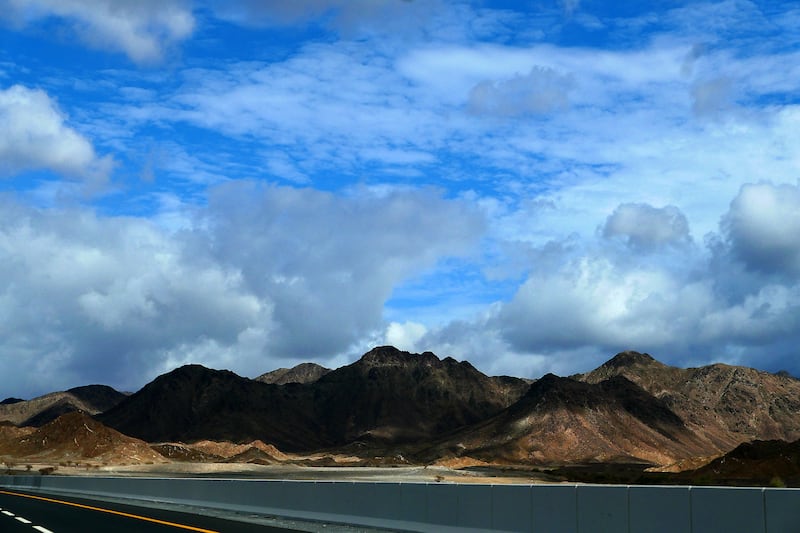 Clouds pass over the tips of mountains in the Northern Emirates. 