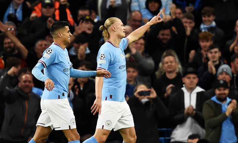 Erling Haaland celebrates with Joao Cancelo. EPA