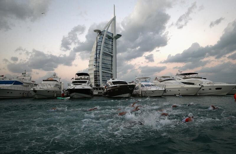 DUBAI, UNITED ARAB EMIRATES - JANUARY 29:  The start of the Men's professional race is pitured during the IRONMAN 70.3 Dubai on January 29, 2016 in Dubai, United Arab Emirates.  (Photo by Warren Little/Getty Images for Ironman)