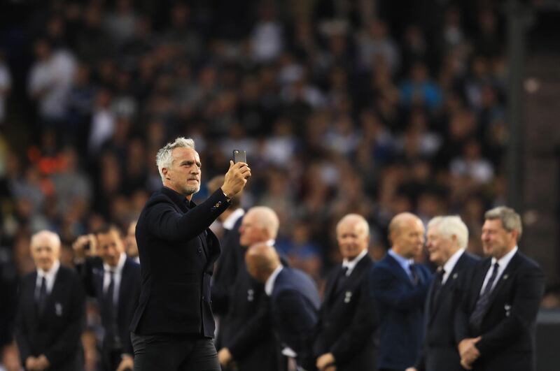 LONDON, ENGLAND - MAY 14:  David Ginola films with with his phone as he walks onto the pitch during the closing ceremony after the Premier League match between Tottenham Hotspur and Manchester United at White Hart Lane on May 14, 2017 in London, England. Tottenham Hotspur are playing their last ever home match at White Hart Lane after their 112 year stay at the stadium. Spurs will play at Wembley Stadium next season with a move to a newly built stadium for the 2018-19 campaign.  (Photo by Richard Heathcote/Getty Images)