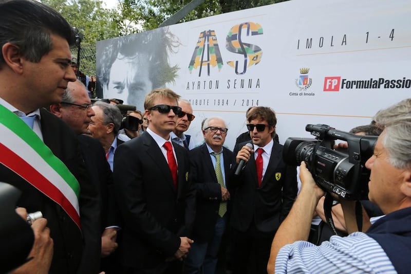 Kimi Raikkonen, left, and Fernando Alonso, right, the present Ferrari drivers, lead the tributes to Ayrton Senna at Imola, 20 years after the Brazilian's death. Mauro Monti / AFP 