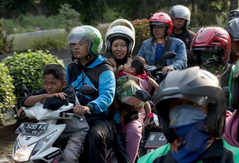 A family rides a motorcycle in Bekasi on the outskirts of Jakarta, Indonesia. AP Photo