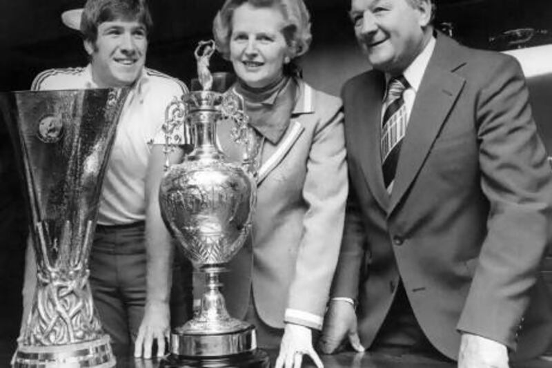 Margaret Thatcher poses with Liverpool's Emlyn Hughes and coach Bob Paisley.