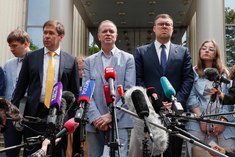 epa09257270 Evgeny Smirnov, Ilya Novikov (2-L), Ivan Pavlov (C), Vladimir Voronin (2-R) and Valeria Vetoshkina (R), lawyers of the Anti-Corruption Foundation (FBK), speak to the press after leaving the Moscow City Court in Moscow, Russia, 09 June 2021. The court continues the hearing, behind the closed doors, on a lawsuit filed by the Moscow Prosecutor's Office to recognize Anti-Corruption Foundation (FBK) and the headquarters of jailed opposition leader Alexei Navalny as extremist organizations. The court suspended the organizations' activities until the decision on the extremism lawsuit.  EPA/YURI KOCHETKOV