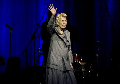 FILE - In this June 18, 2013 file photo, Joni Mitchell waves to the crowd during her 70th birthday tribute concert as part of the Luminato Festival at Massey Hall in Toronto. A woman identified as Mitchell's friend of more than 44 years, Leslie Morris, stated in a Tuesday, April 28, 2015, court filing in Los Angeles that the legendary folk singer is unconscious and unable to care for herself. A doctor's declaration accompanying Morris' petition to be named Mitchell's conservator states the singer-songwriter will not be able to attend any court hearings for at least four to six months, but offers no additional details on Mitchell's illness or prognosis. (Aaron Vincent Elkaim/The Canadian Press, File)