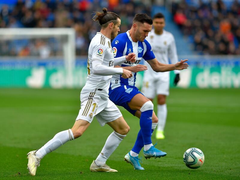 Alaves' Spanish forward Lucas Perez (R) vies with Real Madrid's Welsh forward Gareth Bale. AFP