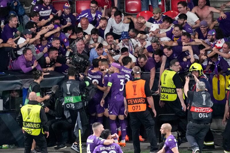 Fiorentina's Giacomo Bonaventura celebrates with teammates and fans after scoring his side's first goal. AP 