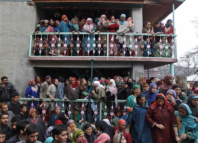 Relatives of election official Mohammad Zia-ul-Haq wail during his funeral at Herpora, south of Srinagar. In an incident on Thursday, Zia-ul-Haq was killed and five people wounded in a gun attack in Indian-ruled Kashmir, where many people stayed away from voting in a constituency that was hit by pre-poll violence. Danish Ismail / Reuters / April 25, 2014