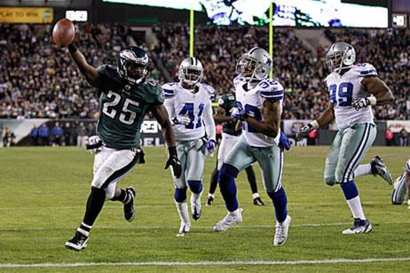 LeSean McCoy, left, celebrates as he runs in a touchdown for the Philadelphia Eagles to help defeat the Dallas Cowboys 34-7.