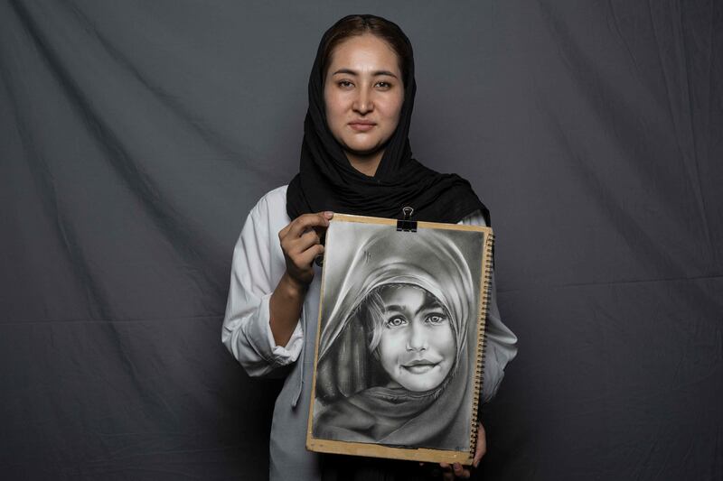 Artist and art teacher Manezha Sultani, 24, poses for a portrait in Herat. 'Before the Taliban took over, I had no fear - I used to attend exhibitions, go to events and see everything I desired. But when the takeover happened, I was afraid of how it would impact my job and my rights,' she says. 'I have not had any good experiences since the Taliban took over.'