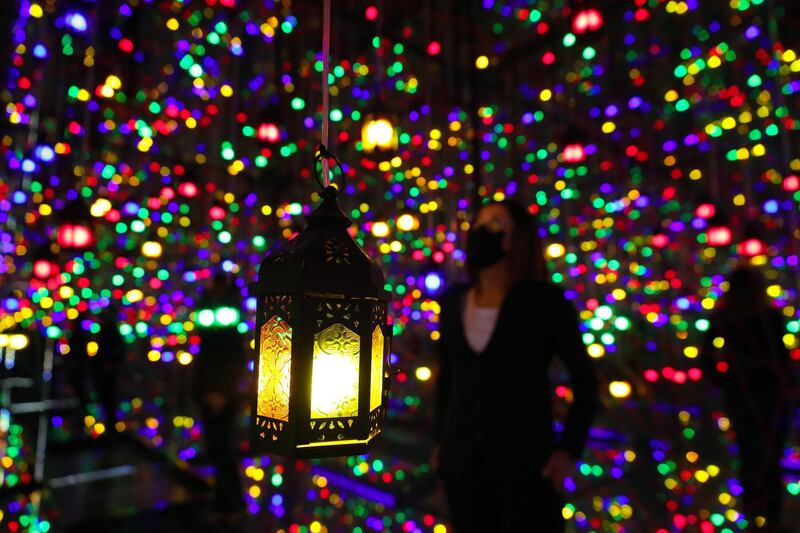 Dubai, United Arab Emirates - Reporter: N/A. Standalone. Ramadan. People visit the Ramadan Reflection room at Ibn Battuta Mall. The room is filled with coloured hanging lamps and mirrors all around. Tuesday, April 20th, 2021. Dubai. Chris Whiteoak / The National