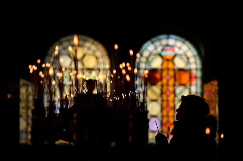 A woman holds a candle as she attends a mass on Christmas at St. Alexander Nevski cathedral in Sofia, Bulgaria. REUTERS/Stoyan Nenov