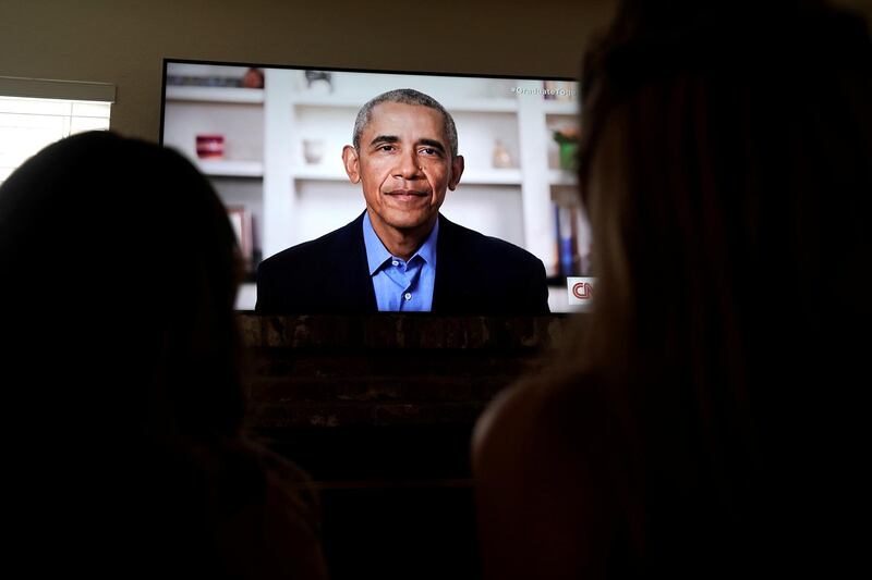 Graduating pupils Phoebe Seip, 18 (right), and her sister Sydney, 22, watch former US President Barack Obama deliver a virtual commencement address to millions of high school seniors who missed graduation ceremonies due to the coronavirus outbreak, in the US, May 16. Bing Guan / Reuters