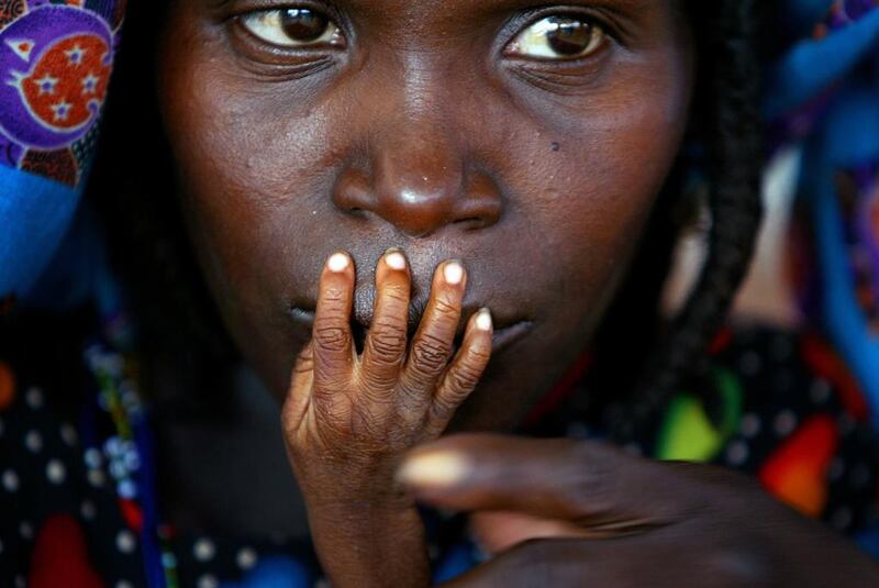 The fingers of malnourished one-year-old Alassa Galisou are pressed against the lips of his mother Fatou Ousseini at an emergency feeding clinic in the town of Tahoua in northwestern Niger, on August 1, 2005. Finbarr O’Reilly / Reuters