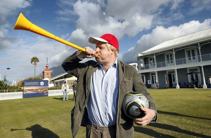 London Mayor Boris Johnson blows a vuvuzela during his visit to Waterfront in Cape Town, June 16, 2010    REUTERS/Oleg Popov   (SOUTH AFRICA - Tags: SPORT SOCCER WORLD CUP POLITICS)