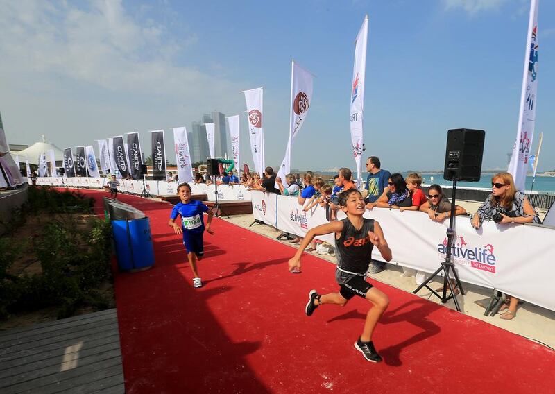 Children in the under 13 category race to the finish line at the Corniche in Abu Dhabi. Ravindranath K / The National