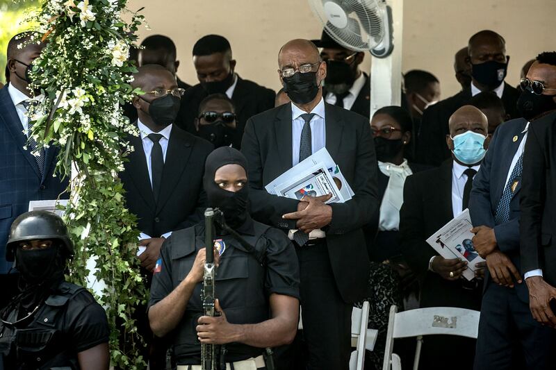 Haiti's Prime Minister Ariel Henry, centre, attends the funeral for slain Haitian president Jovenel Moïse. AFP