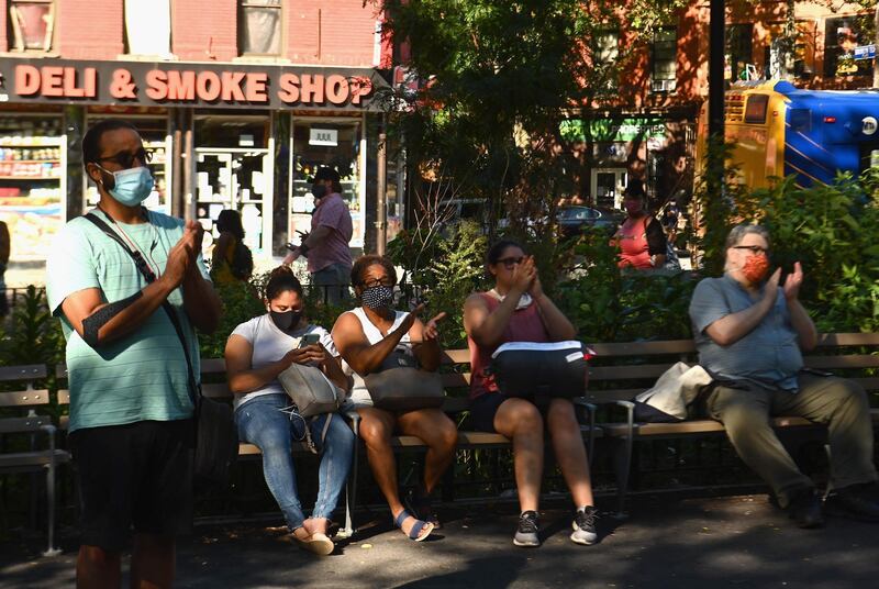 People watch musicians of the New York Philharmonic play with their 'bandwagon's pop-up concert series' at Betty Carter Park. AFP