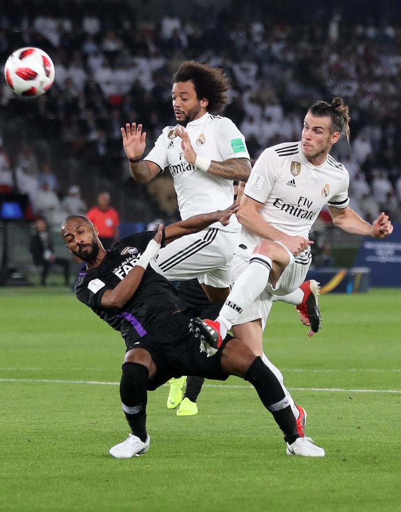 Abu Dhabi, United Arab Emirates - December 22, 2018: Gareth Bale (R) and Marcelo of Real Madrid compete with Mohamed Ahmad of Al Ain during the match between Real Madrid and Al Ain at the Fifa Club World Cup final. Saturday the 22nd of December 2018 at the Zayed Sports City Stadium, Abu Dhabi. Chris Whiteoak / The National