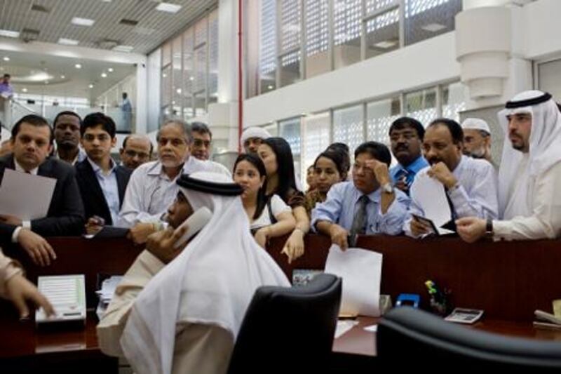 Dubai - October 28, 2008: People attempt to apply for the new ID card  at the Emirates Identity Authority at the Dubai Central Post Office. ( Philip Cheung / The National )