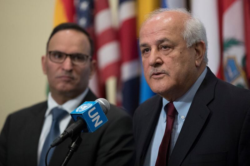 Riyad Mansour, Palestinian Ambassador to the United Nations, speaks to the media as Mansour Ayyad Al-Otaibi, Kuwaiti Ambassador to the United Nations, left, listens after an emergency Security Council meeting on the situation in Gaza, Friday, March 30, 2018, at United Nations headquarters. (AP Photo/Mary Altaffer)