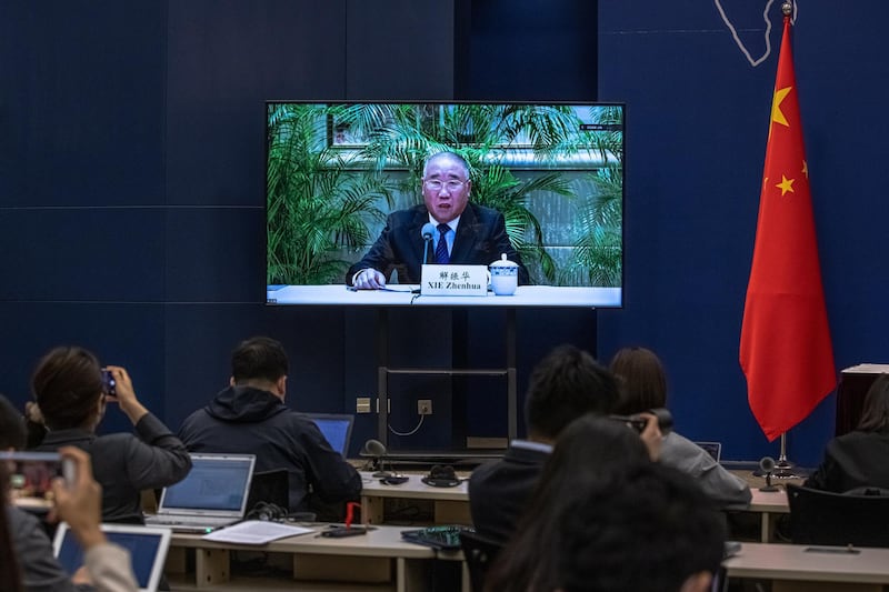 epa09152991 A screen shows Xie Zhenhua, China's Special Envoy for Climate Change, speaking during a media briefing on Chinese President Xi Jinping's attendance at virtual international Leaders Summit on Climate, at the Ministry of Foreign Affairs, in Beijing, China, 22 April 2021.  Around 40 international leaders attended the summit called by US President Biden. The meeting is intended to underline the urgency and economic benefits of stronger climate action on the road to the United Nations Climate Change Conference (COP26) in Glasgow in November 2021.  EPA/ROMAN PILIPEY