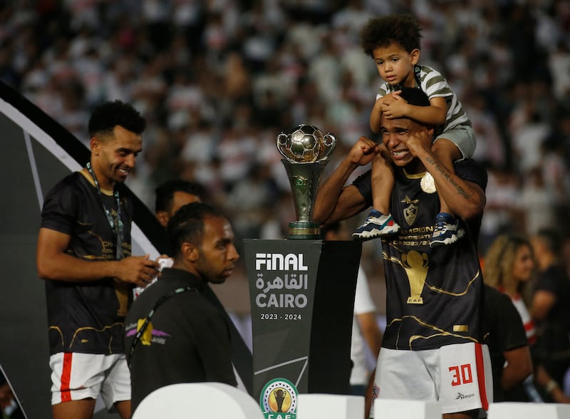 Zamalek's Seifeddine Jaziri celebrates with his son after winning the Confederation Cup at the Cairo International Stadium. Reuters