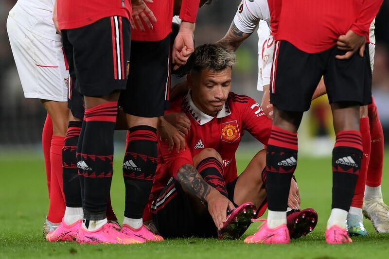 MANCHESTER, ENGLAND - APRIL 13: Lisandro Martinez of Manchester United goes down with an injury during the UEFA Europa League quarterfinal first leg match between Manchester United and Sevilla FC at Old Trafford on April 13, 2023 in Manchester, England. (Photo by Shaun Botterill / Getty Images)