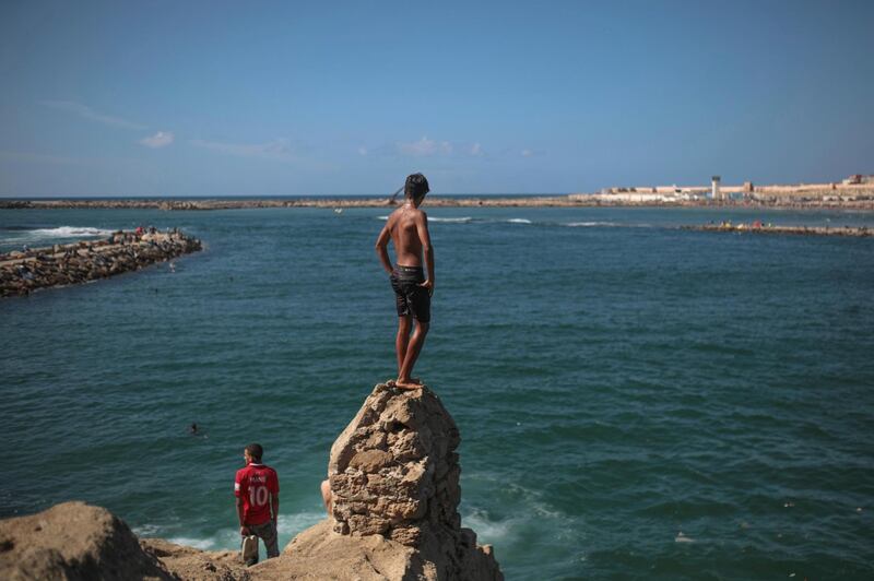 A boy pauses before taking a plunge into the ocean on a hot afternoon in Rabat, Morocco.  AP