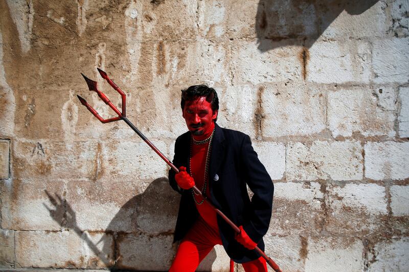 A member of the “Los Sidros” folk group poses for a photo before taking part in the 12th Iberian Mask parade in Lisbon. Rafael Marchante / Reuters