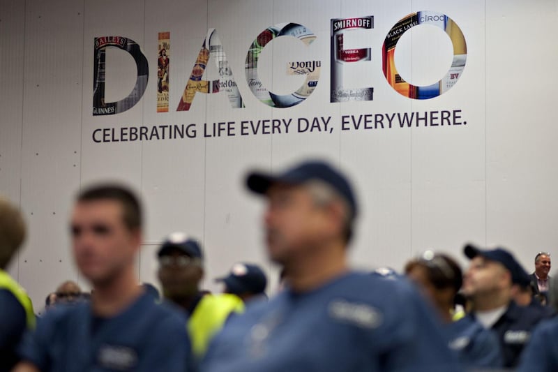 Diageo Plc signage is displayed as employees wait for the start of an event at the company's North America bottling facility in Plainfield, Illinois, U.S., on Tuesday, Aug. 6, 2013. Diageo Plc, the world's biggest distiller, recently completed a $120 million dollar expansion and modernization at the bottling facility, the largest North America. Photographer: Daniel Acker/Bloomberg