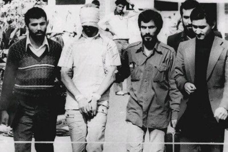 An American hostage held at the US Embassy in Tehran is shown blindfolded and with his hands bound in November 9, 1979.  Fifty-two of the hostages endured 444 days of captivity.