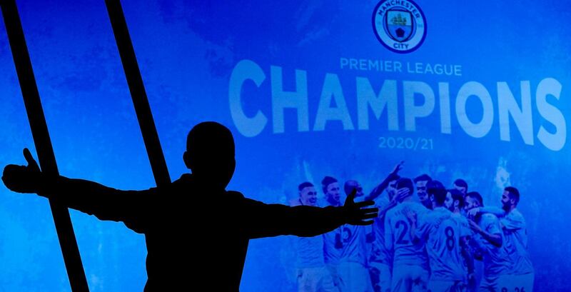 A Manchester City supporter celebrates outside the Etihad Stadium. AP