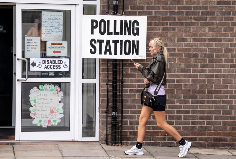 A voter arrives a polling station at Selby Community Centre in North Yorkshire. PA