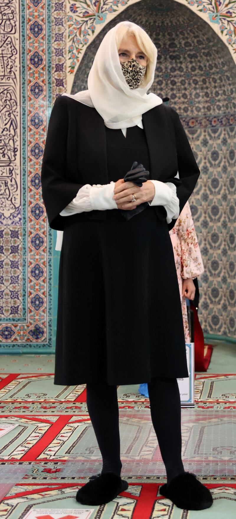 To tour the mosque, the Duchess of Cornwall removed her boots and put on faux-fur slippers, suitable for the indoors. AFP