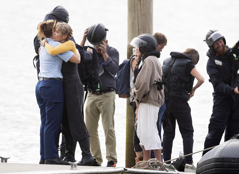 Family disembark from a speedboat after being on the HMNZS Wellington where they observed a minutes silence near White Island in Whakatane, New Zealand. Getty Images