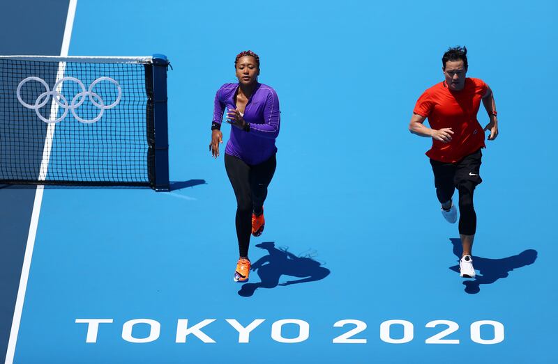 Naomi Osaka runs on the court during training ahead of the Tokyo Olympic Games.
