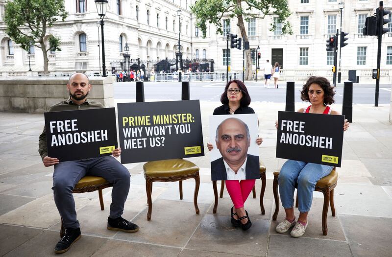 Sherry Izadi, Elika Ashoori and Aryan Ashoori, the family of Anoosheh Ashoori, a British man currently jailed in Iran, stage an 'empty chair' protest opposite Downing Street last year. Reuters