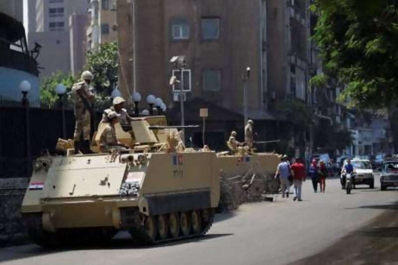 Soldiers guard the streets in Cairo yesterday after the army removed Mohammed Morsi as president last week. Hiro Komae / AP Photo