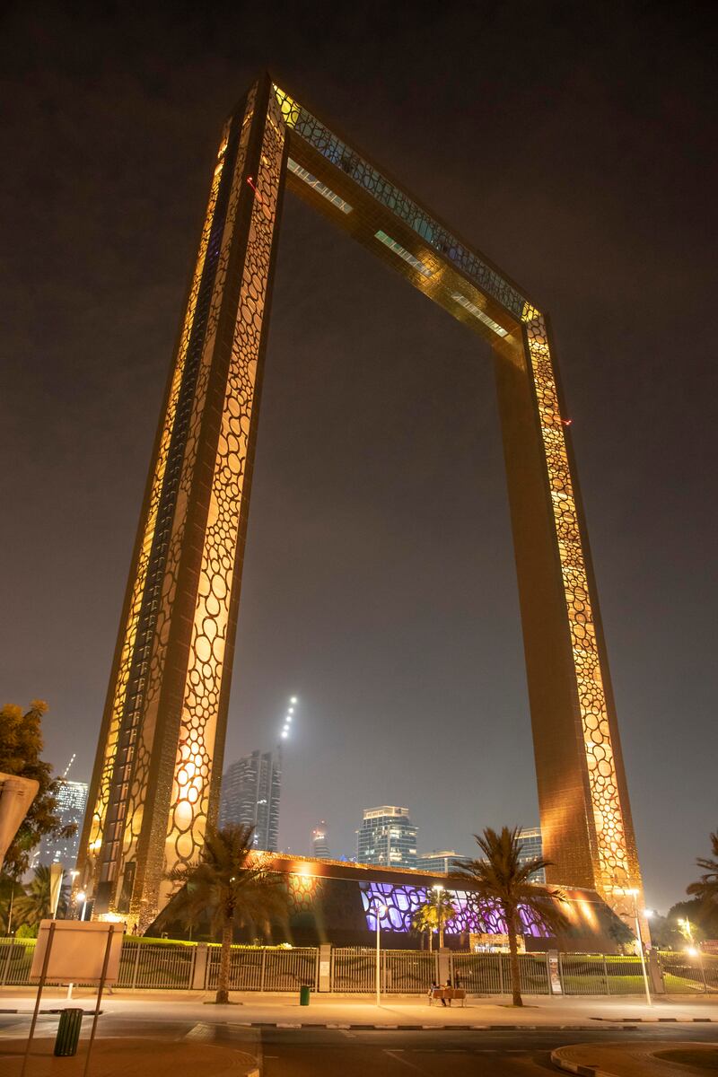 Dubai Frame is illuminated in yellow. Antonie Robertson / The National